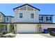 Charming two-story townhome with an attached garage and well-maintained landscaping, offers a welcoming curb appeal at 32046 Powderpuff Mimosa Dr, San Antonio, FL 33576