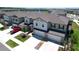 Aerial view of townhomes with well maintained lawns and landscaping at 32046 Powderpuff Mimosa Dr, San Antonio, FL 33576