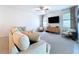 Living room with neutral color palette, stylish furnishings, and plenty of natural light at 32046 Powderpuff Mimosa Dr, San Antonio, FL 33576