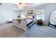 Bright main bedroom with soft carpet, natural lighting, and tastefully coordinated furniture and decor at 32046 Powderpuff Mimosa Dr, San Antonio, FL 33576