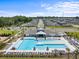 Aerial view of community pool and clubhouse, showcasing the neighborhood layout and amenities at 36519 Garden Wall Way, Zephyrhills, FL 33541