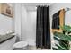 A clean, well-maintained bathroom featuring a shower with black accents and white tile at 36519 Garden Wall Way, Zephyrhills, FL 33541