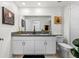 The primary bathroom features dual sinks, granite counters, and framed mirrors at 36519 Garden Wall Way, Zephyrhills, FL 33541