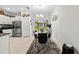 Dining area adjacent to kitchen featuring modern chandelier and artwork at 36519 Garden Wall Way, Zephyrhills, FL 33541