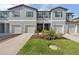 Attractive townhome exteriors with a well-kept lawn and coordinated landscaping at 36519 Garden Wall Way, Zephyrhills, FL 33541
