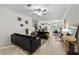 Open concept living area flowing into the kitchen, featuring tile flooring and modern finishes at 36519 Garden Wall Way, Zephyrhills, FL 33541