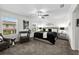 A beautifully staged main bedroom with a ceiling fan, stylish furniture, and a relaxing atmosphere at 36519 Garden Wall Way, Zephyrhills, FL 33541