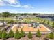 Aerial view of the community playground featuring modern play equipment, safety surfacing, and nearby tennis courts at 36519 Garden Wall Way, Zephyrhills, FL 33541