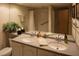 Bathroom featuring double sinks, a granite countertop, a large mirror, and a combined tub and shower at 36750 Us 19 N # 3-124, Palm Harbor, FL 34684