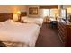 Comfortable bedroom with two beds, a work desk, and warm lighting at 36750 Us 19 N # 3-124, Palm Harbor, FL 34684