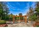 Charming community swing set surrounded by lush landscaping, offering a serene outdoor space at 36750 Us 19 N # 3-124, Palm Harbor, FL 34684
