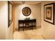 Elegant foyer featuring a console table with decor, a round mirror, and framed artwork at 36750 Us 19 N # 3-124, Palm Harbor, FL 34684