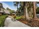 Exterior view of the well-maintained condominium building with mature trees at 36750 Us 19 N # 3-124, Palm Harbor, FL 34684