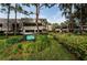 Inviting exterior of Carnoustie condos with lush landscaping, mature trees, and a welcoming sign at 36750 Us 19 N # 3-124, Palm Harbor, FL 34684