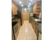Efficient kitchen with stainless steel appliances, warm wood cabinets, and neutral countertops at 36750 Us 19 N # 3-124, Palm Harbor, FL 34684