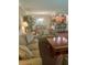 Cozy living room with comfortable seating and an open view to the dining area and the kitchen at 36750 Us 19 N # 3-124, Palm Harbor, FL 34684