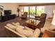 Spacious living room featuring a large window, comfortable furniture, and a view of the outdoors at 36750 Us 19 N # 3-124, Palm Harbor, FL 34684