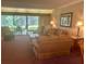 Cozy living room featuring comfortable seating, a large window with a view, and warm lighting at 36750 Us 19 N # 3-124, Palm Harbor, FL 34684