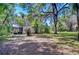 Expansive backyard featuring mature trees and a charming home, perfect for outdoor activities and relaxation at 4041 Lane Rd, Zephyrhills, FL 33541