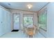 Dinette with a table, chairs, and a view to the back yard through a bright window at 4041 Lane Rd, Zephyrhills, FL 33541