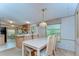Inviting dining area features a large table with seating for eight, adjacent to kitchen at 4041 Lane Rd, Zephyrhills, FL 33541
