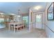 Inviting dining area features a large table with seating for eight, adjacent to kitchen at 4041 Lane Rd, Zephyrhills, FL 33541