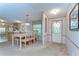 Inviting dining area features a large table with seating for eight, adjacent to kitchen at 4041 Lane Rd, Zephyrhills, FL 33541