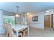 Inviting dining area features a large table with seating for eight, adjacent to kitchen at 4041 Lane Rd, Zephyrhills, FL 33541
