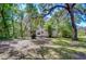 A quaint home nestled among mature trees, providing a private and shaded setting with natural beauty at 4041 Lane Rd, Zephyrhills, FL 33541