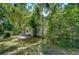 Quaint home partially obscured by lush foliage, offering privacy and a connection to nature at 4041 Lane Rd, Zephyrhills, FL 33541