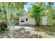 Charming single-story home with a screened porch and mature trees in a lush, green setting at 4041 Lane Rd, Zephyrhills, FL 33541