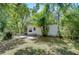 Exterior featuring house, landscaped yard, and surrounding trees at 4041 Lane Rd, Zephyrhills, FL 33541