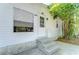 Charming home entrance with steps and a well-lit front door at 4041 Lane Rd, Zephyrhills, FL 33541