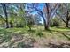 Lush front yard with mature trees and flowers, complementing the home's exterior and adding to its curb appeal at 4041 Lane Rd, Zephyrhills, FL 33541