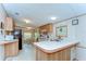 Well-lit kitchen with ample counter space, modern appliances, and an adjacent dining area for easy meals at 4041 Lane Rd, Zephyrhills, FL 33541