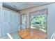 Cozy kitchen with a wooden table, white chairs, and a large window overlooking the outdoors at 4041 Lane Rd, Zephyrhills, FL 33541