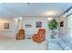 Comfortable seating area with an accent plant creating a cozy space bathed in natural light at 4041 Lane Rd, Zephyrhills, FL 33541