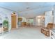 Open-concept living space with a comfortable chair, flowing into the dining area and kitchen at 4041 Lane Rd, Zephyrhills, FL 33541
