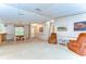 Expansive living area with seating, wall decor, and a view to an adjoining dinette and entry at 4041 Lane Rd, Zephyrhills, FL 33541