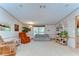 Bright living room features comfortable seating, wall decor, and shelving, creating a cozy atmosphere at 4041 Lane Rd, Zephyrhills, FL 33541