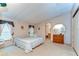 Relaxing main bedroom with a queen bed, dresser, en-suite access, and neutral decor at 4041 Lane Rd, Zephyrhills, FL 33541