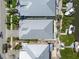 Overhead shot of a property, highlighting the roof, landscaping, and proximity to waterfront and neighboring homes at 424 Bahama Grande Blvd, Apollo Beach, FL 33572