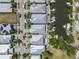 Aerial view showcasing waterfront homes, docks, boats, and well-manicured lawns in a residential neighborhood at 424 Bahama Grande Blvd, Apollo Beach, FL 33572
