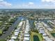 Expansive aerial view of a waterfront community with canals, lush landscaping, and beautiful homes under a bright blue sky at 424 Bahama Grande Blvd, Apollo Beach, FL 33572