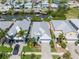 Stunning aerial view of a waterfront property with lush landscaping, a paver driveway, and a well-maintained exterior at 424 Bahama Grande Blvd, Apollo Beach, FL 33572