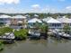 Scenic aerial view of waterfront homes with private boat docks and lifts situated along the canals of the neighborhood at 424 Bahama Grande Blvd, Apollo Beach, FL 33572