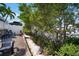 Charming backyard featuring a waterfront view, lush landscaping, and a cozy seating area for relaxation at 424 Bahama Grande Blvd, Apollo Beach, FL 33572