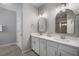 Bathroom featuring double sinks, white cabinetry, and stylish lighting fixtures above each sink at 424 Bahama Grande Blvd, Apollo Beach, FL 33572