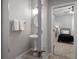 View through doorway to a bathroom with sink and into bedroom with a ceiling fan at 424 Bahama Grande Blvd, Apollo Beach, FL 33572