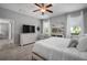Bright bedroom featuring soft carpet, a ceiling fan, and a dresser with a TV at 424 Bahama Grande Blvd, Apollo Beach, FL 33572